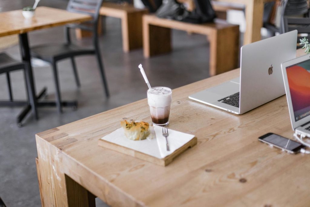 Calm scene with a glass on wood, background to someone working out how to write a book.