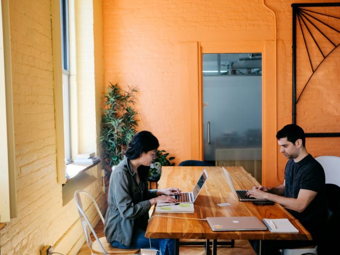 Joint laptop session where to-do list detours become productive procrastination.