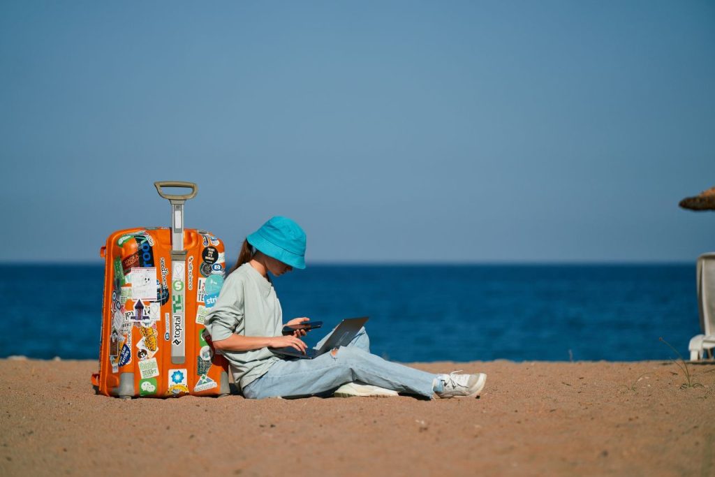 Woman at her desk, practicing literary citizenship by supporting other writers online.