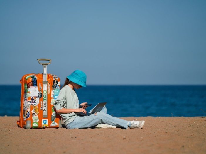 Woman at her desk, practicing literary citizenship by supporting other writers online.
