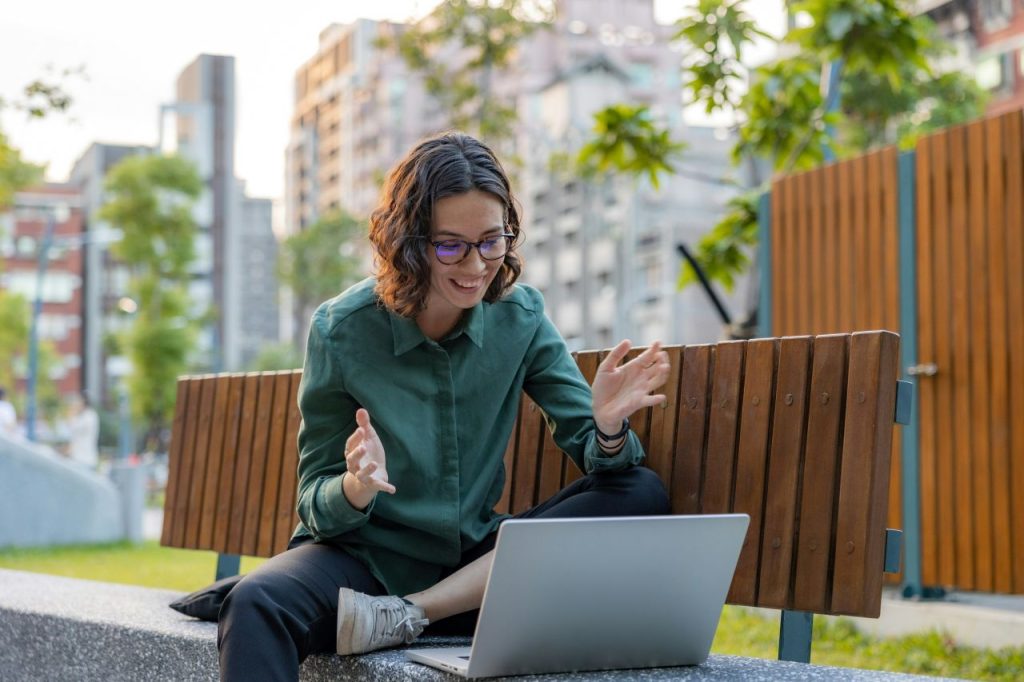 Outdoor video call where a writer discusses a potential book deal.