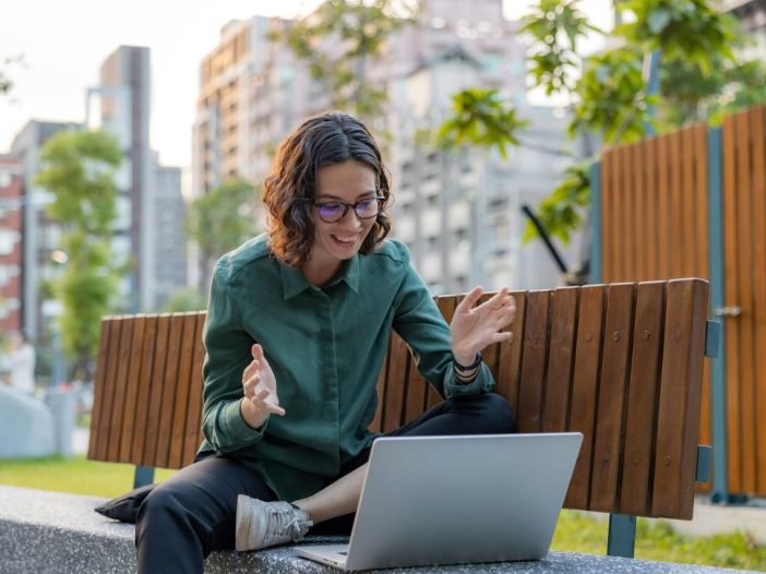 Outdoor video call where a writer discusses a potential book deal.