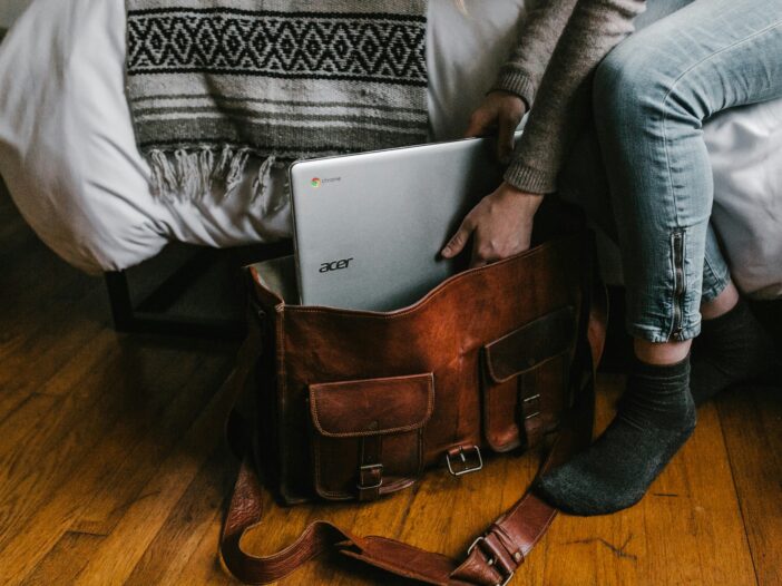 A person packing a bag, symbolizing the role of journalists in seeking and reporting solutions to societal challenges—core to solutions journalism.
