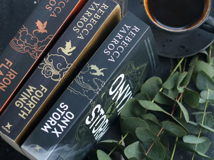 Stacked novels with coffee, perfect for escaping into romantasy worlds