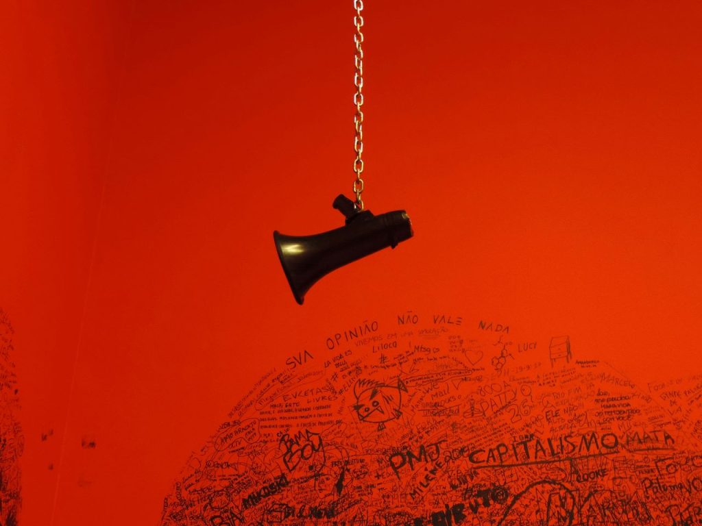 Close-up of a black megaphone charm, a nod to how to write an op-ed with impact.