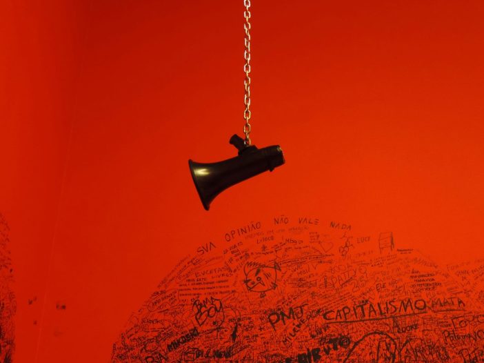 Close-up of a black megaphone charm, a nod to how to write an op-ed with impact.