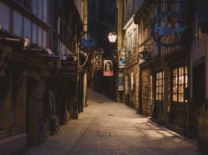 Enchanted alleyway at dusk, ideal for imagining how to write a cozy mystery set in a small town.